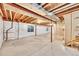 Unfinished basement space with exposed wood ceiling, concrete floor and insulated walls at 16500 Hitching Post Cir, Parker, CO 80134