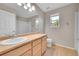 Bathroom featuring a large mirror, natural wood cabinets, and tile floors at 16500 Hitching Post Cir, Parker, CO 80134