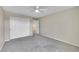 Spacious bedroom with carpet flooring, closet, and a ceiling fan that provides comfort at 16500 Hitching Post Cir, Parker, CO 80134