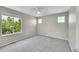 Spacious carpeted bedroom with large windows offering natural light and views of lush greenery at 16500 Hitching Post Cir, Parker, CO 80134