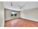 Bonus room with hardwood floors, ceiling fan, and large window allowing lots of natural light at 16500 Hitching Post Cir, Parker, CO 80134