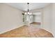 Elegant dining room showcasing tile flooring, a modern chandelier, and large windows providing plenty of natural light at 16500 Hitching Post Cir, Parker, CO 80134