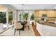 Bright dining room with modern chandelier, light walls, and large sliding glass door to backyard at 16500 Hitching Post Cir, Parker, CO 80134