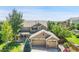 Charming two-story home with a three-car garage, complemented by mature trees and professional landscaping at 16500 Hitching Post Cir, Parker, CO 80134