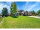 Stunning home with a well-kept lawn, mature trees, and charming front porch, complemented by a convenient three-car garage at 16500 Hitching Post Cir, Parker, CO 80134