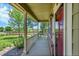 Inviting front porch showcasing a covered entryway, white railing, and beautifully landscaped surroundings, providing a warm welcome at 16500 Hitching Post Cir, Parker, CO 80134