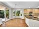 Bright eat-in kitchen with wood floors, light wood cabinets and stainless appliances at 16500 Hitching Post Cir, Parker, CO 80134