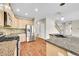 Bright kitchen with stainless steel appliances, granite countertops, and hardwood floors at 16500 Hitching Post Cir, Parker, CO 80134
