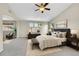 Beautiful primary bedroom featuring vaulted ceiling, ceiling fan, sitting area and multiple windows at 16500 Hitching Post Cir, Parker, CO 80134