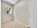 Practical mud room featuring neutral walls, tile flooring, a window for natural light, and a convenient exterior door at 16500 Hitching Post Cir, Parker, CO 80134