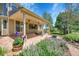 Covered patio featuring ceiling fans, elegant landscaping, and comfortable seating at 16500 Hitching Post Cir, Parker, CO 80134