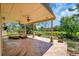 Covered patio with ample seating, ceiling fans, and picturesque view of the lush backyard at 16500 Hitching Post Cir, Parker, CO 80134
