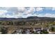 A scenic view of the community nestled amongst rolling hills, with a clear blue sky and puffy white clouds at 17145 Park Trail Dr, Monument, CO 80132