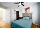 Bright bedroom with wood floors, ceiling fan, closet, and natural light, creating a peaceful retreat at 17145 Park Trail Dr, Monument, CO 80132