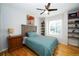 Cozy bedroom with hardwood floors, ceiling fan and a built-in shelving unit at 17145 Park Trail Dr, Monument, CO 80132