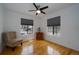 Bright bedroom with hardwood floors, ceiling fan, and large windows at 17145 Park Trail Dr, Monument, CO 80132
