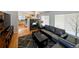 Bright living room with hardwood floors, stone fireplace, and an open view of the kitchen at 17145 Park Trail Dr, Monument, CO 80132