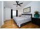Serene primary bedroom with hardwood floors, ceiling fan, and a large window at 17145 Park Trail Dr, Monument, CO 80132