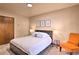 Bedroom with double bed and orange accent chair at 6220 Arapahoe Dr, Evergreen, CO 80439