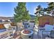 Hot tub on deck with fire pit and seating at 6220 Arapahoe Dr, Evergreen, CO 80439