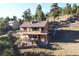 Two-story home with deck and hot tub at 6220 Arapahoe Dr, Evergreen, CO 80439