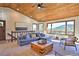 Living room with vaulted ceiling, wood beams and mountain view at 6220 Arapahoe Dr, Evergreen, CO 80439