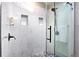 Modern shower with marble tile and glass enclosure at 6220 Arapahoe Dr, Evergreen, CO 80439