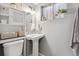 Charming bathroom with pedestal sink, classic fixtures, and natural light from window at 3383 S Boston Ct, Denver, CO 80231