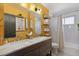 Bathroom boasts double sinks, marble countertop, and ample storage with modern decor at 3383 S Boston Ct, Denver, CO 80231