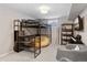 Stylish bedroom features a loft bed, cozy seating area, and entertainment setup at 3383 S Boston Ct, Denver, CO 80231