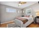 Cozy bedroom features hardwood floors, ceiling fan, bright windows and a comfy daybed at 3383 S Boston Ct, Denver, CO 80231