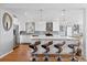 Beautiful kitchen featuring a large center island with pendant lighting and stainless steel appliances at 3383 S Boston Ct, Denver, CO 80231