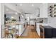 Bright kitchen features a large island with stainless appliances and modern lighting at 3383 S Boston Ct, Denver, CO 80231