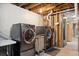 Functional laundry area with side-by-side washer and dryer, and exposed utility elements at 3383 S Boston Ct, Denver, CO 80231