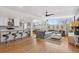 Open-concept living room featuring hardwood floors, modern decor and large picture window at 3383 S Boston Ct, Denver, CO 80231
