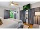 Main bedroom with barn door access to ensuite bathroom, and contemporary gray curtains at 3383 S Boston Ct, Denver, CO 80231