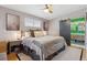 Tastefully decorated main bedroom with ceiling fan, opens to bright bathroom with modern floating vanity at 3383 S Boston Ct, Denver, CO 80231