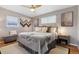 Bright main bedroom features hardwood floors, ceiling fan and curated decor with a luxurious feel at 3383 S Boston Ct, Denver, CO 80231
