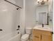 Clean bathroom with tub, shower, and light vanity at 10155 Morrison Rd, Lakewood, CO 80227