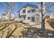 Backyard view of multi-story home, patio, deck, and mature landscaping at 5331 S Dunkirk Way, Centennial, CO 80015