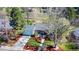 Aerial view of a well-maintained home featuring lush landscaping, mature trees, and an inviting front entrance at 2261 W Briarwood Ave, Littleton, CO 80120