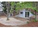 A backyard features a patio, mature trees, landscaping, and a shed at 2261 W Briarwood Ave, Littleton, CO 80120