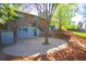 Backyard features an ivy-covered exterior, mature trees and a concrete patio area at 2261 W Briarwood Ave, Littleton, CO 80120
