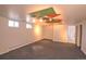 Finished basement with carpeting features colorful ceiling accents and windows for natural light at 2261 W Briarwood Ave, Littleton, CO 80120