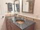 Bathroom vanity features a dark countertop, copper vessel sink, and updated tile backsplash at 2261 W Briarwood Ave, Littleton, CO 80120