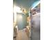 Well-lit bathroom featuring updated fixtures, colorful shower tiling, and ample storage space at 2261 W Briarwood Ave, Littleton, CO 80120