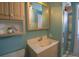 Full bath features updated vanity, ample storage, and colorful tile surround in the shower at 2261 W Briarwood Ave, Littleton, CO 80120