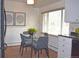 Cozy dining area with a glass table, modern chairs, and natural light at 2261 W Briarwood Ave, Littleton, CO 80120
