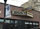 Exterior view of The Alley bar and grill featuring lighted signs and a prominent display of upcoming live music events at 2261 W Briarwood Ave, Littleton, CO 80120