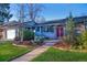 Attractive single-story home with a well manicured lawn and garden in front yard at 2261 W Briarwood Ave, Littleton, CO 80120